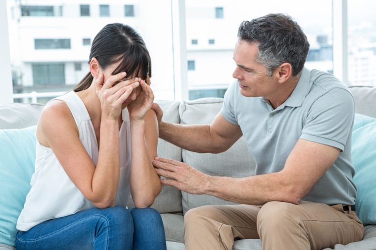 Therapist consoling a woman in the clinic